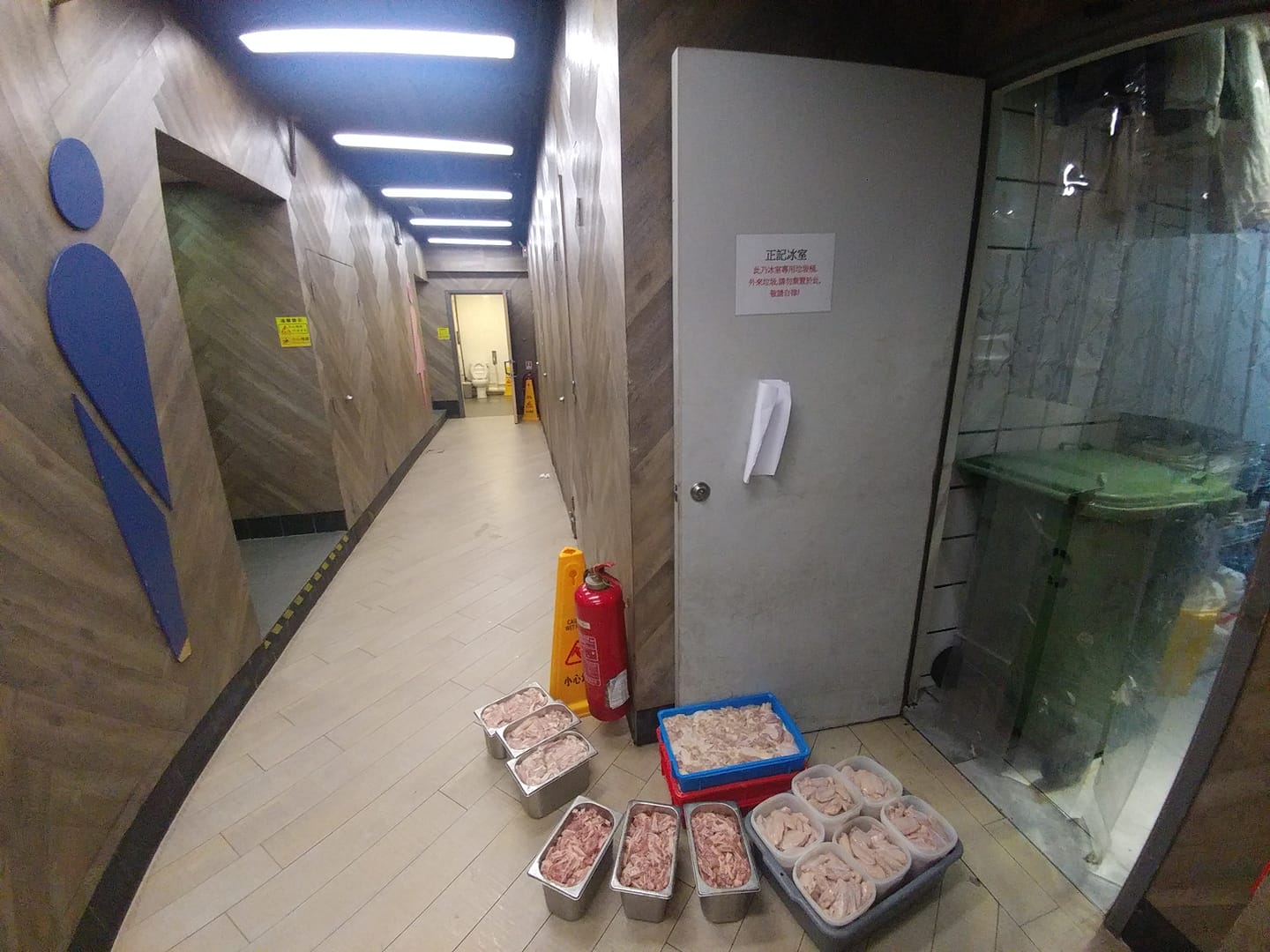 Uncovered raw meat left on restaurant floor near garbage bin of Tai Wo