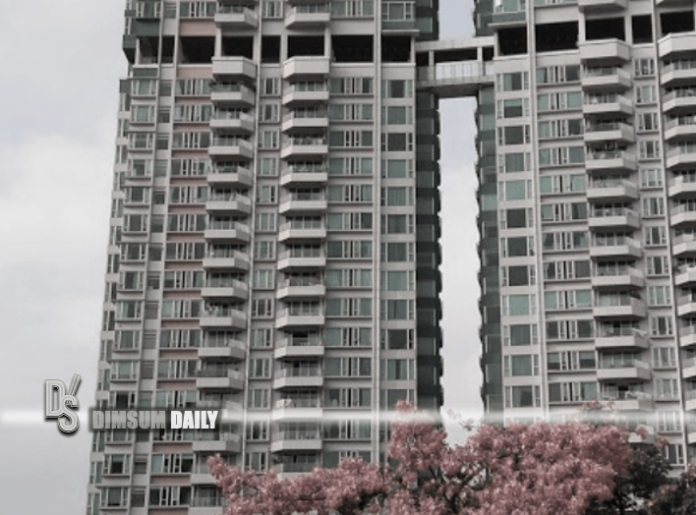 Man sits precariously on window ledge of apartment at Harbour Green in