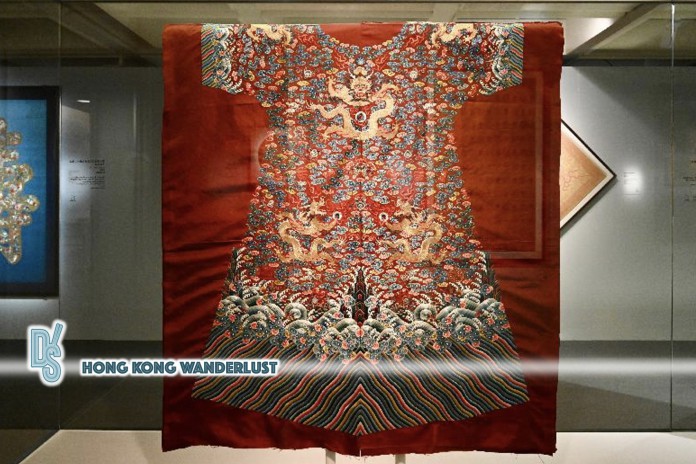 Picture shows a yardage of deep-red brocade satin robe embroidered with bats, clouds, gold dragons and 12 imperial symbols from the Qianlong period of the Qing dynasty.