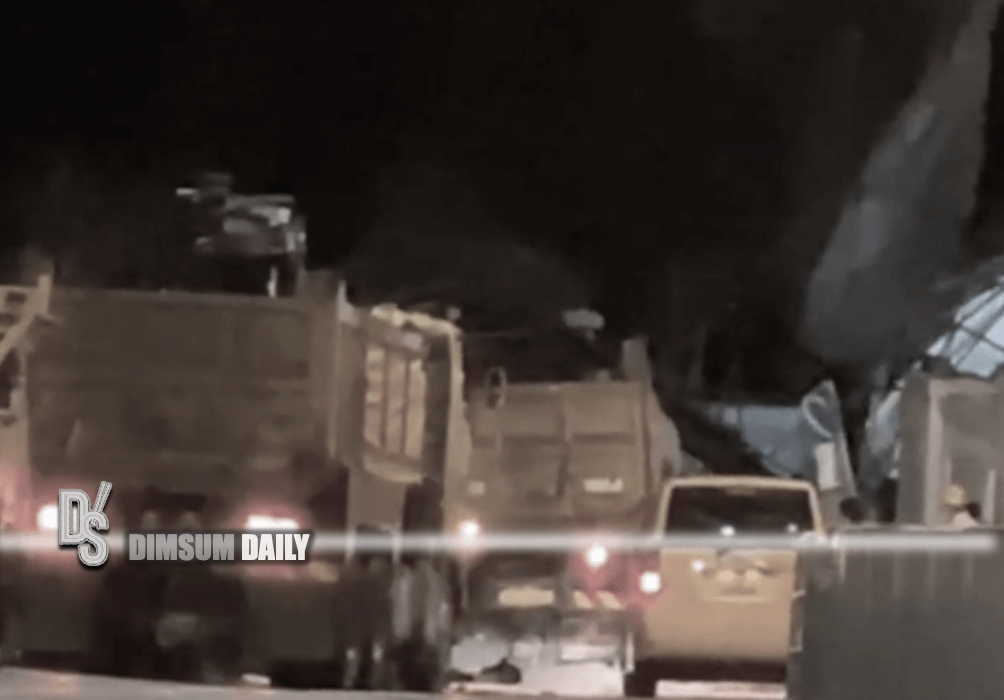 Workers work overnight to clear the collapsed bamboo scaffold on