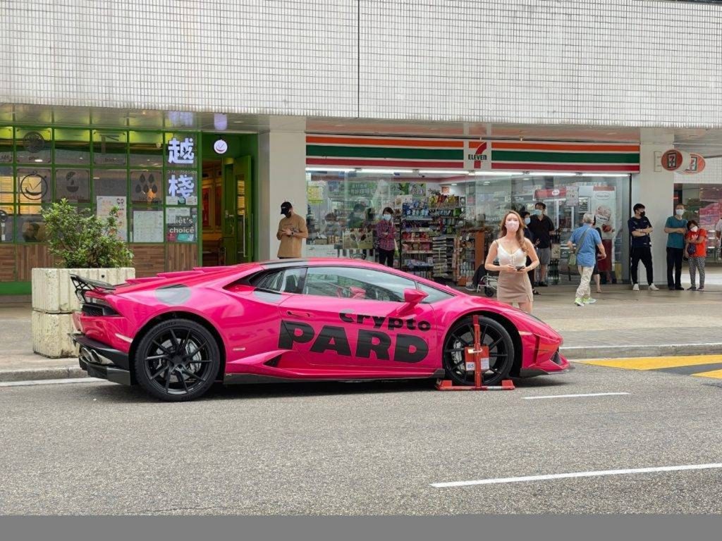 Dark pink Lamborghini sports car clamped near City One - Shatin during ...