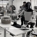 Tesla unveils Optimus, the latest model of its humanoid robot, demonstrating its remarkable skill of shirt folding