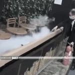 Security officer extinguishes flaming handbag at Starbucks in Langham Place, Mong Kok