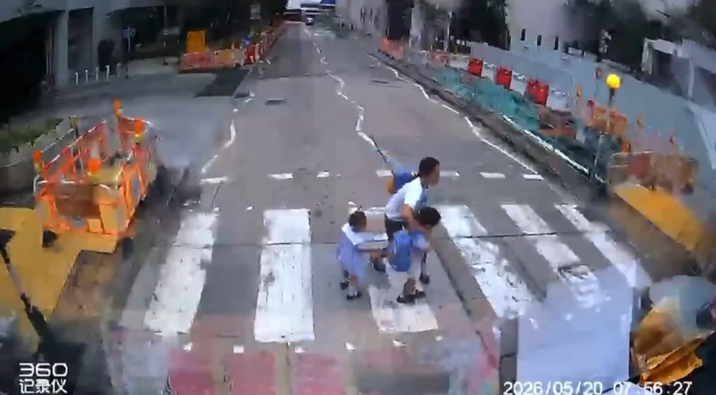 Foreign domestic helper hailed after saving young pupils from oncoming car