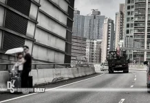 Pair seen standing with luggage on busy Hung Hom Bypass