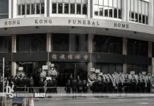 National flag covers Tung Chee-hwa’s coffin as hearse leaves North Point
